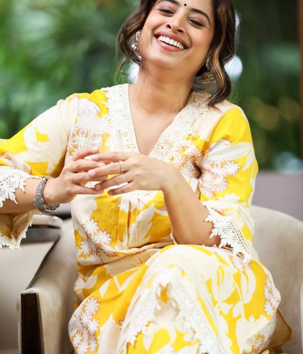 Smiling person sitting comfortably after a yoga session.
