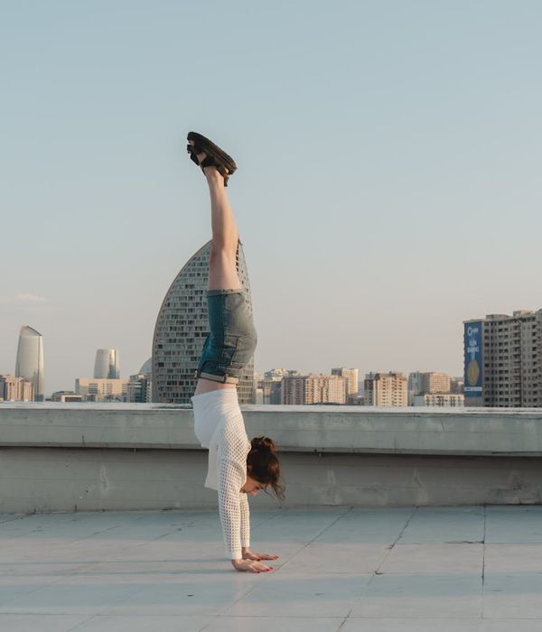 Woman in a calming yoga pose, bathed in warm light.